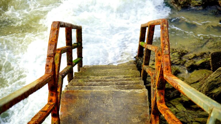 Rusted Steps Coming Out of Angry Ocean